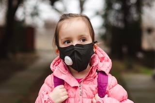 Portrait of a little girl wearing pollution mask going to kindergarten.
