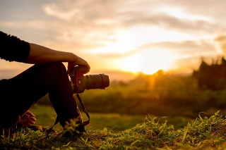 Nature photographer , Photographer are sitting look the sunset
