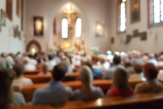 Blurred photo of praying people in the church for abstract background
