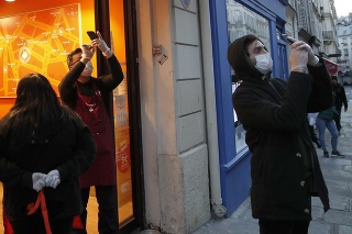 Pohľad na ľudí v ochranných rúškach v uliciach Paríža