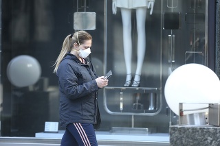 Žena s ochranným ráškom kráča ulicami Viedne.