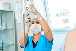 The medical worker adjusts the dropper to stimulate the patient