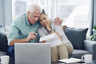 Shot of a senior couple going through paperwork at home