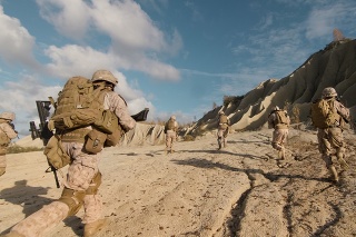 Shot of a Squad of Soldiers Running Forward and Atacking Enemy During Military Operation in the Desert.