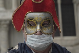 Ruský turista s maskou a ochranným rúškom na tvári počas návštevy Námestia sv. Marka v Benátkach