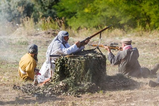 SAMBEK, ROSTOV REGION, RUSSIA, AUGUST 19, 2018: Historical festival Sambek Heights. Mujahideen shoot from behind cover