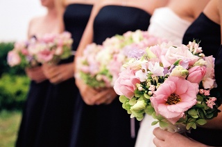 Bridesmaids with flowers - foreground only in focus. Beautiful Springtime bouquets in pink and green.
