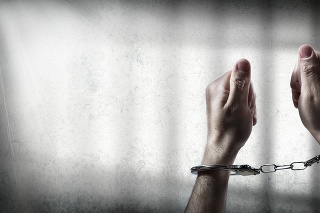 hand with handcuff, arrested in prison