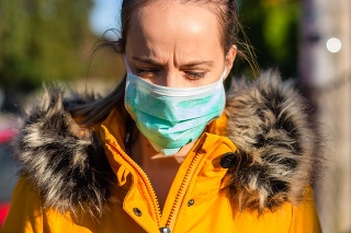 Young woman walking on the road with flu mask.