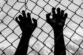 silhouette of the boy holding the cage , imprisoned, retarded, Child Abuse in white tone
