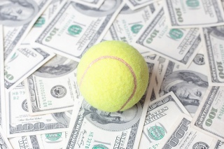 tennis ball on bank notes