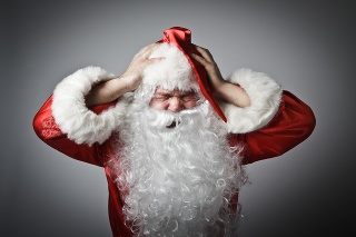 Frustrated Santa Claus. Santa Claus suffering from headache.
