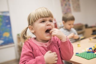 Portrait of tearful child girl in kindergarten