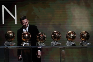 Na snímke argentínsky útočník Lionel Messi si prezerá svoju šesticu Zlatých lôpt na vyhlásení ankety Zlatá lopta France Football v Paríži.