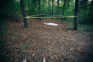 Dead body covered with sheet on murder crime scene