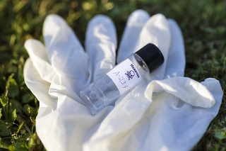Small plastic bottle with inscription Novichok and protective gloves