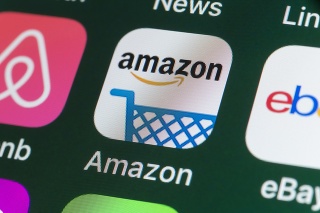 London, UK - July 31, 2018: The buttons of the online shopping app Amazon, surrounded by Airbnb, ebay, News and other apps on the screen of an iPhone.