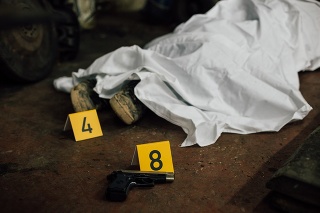 A photo showing covered dead body and founded evidence while investigating a crime scene.