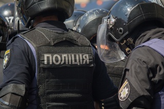 Kiev, Ukraine - June 18, 2017: Ukrainian policemen guard gay parade participants. The inscription on the back 