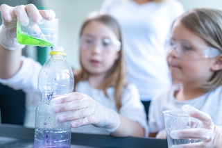 Close up of two schoolgirls doing experiment on a chemistry class.