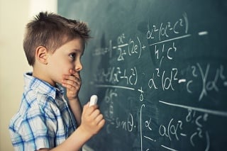 Little boy in math class overwhelmed by the math formula.