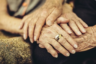 Senior man holding his wife's hand