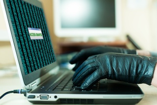 Close up View of Hands of Hacker using Gloves to avoid leaving fingertips managed to get an access to database