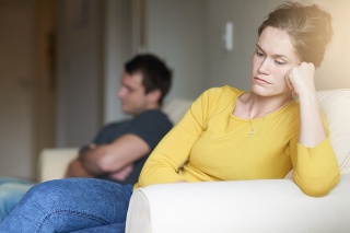 Cropped shot of an unhappy young couple sitting on the couch at home after a fight