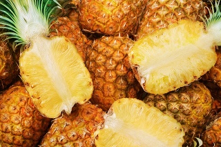 more then one pineapple with some cut in half.