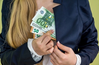woman hides a pocket euro money isolated on green