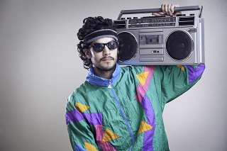 A cool, funky young hipster adult from the late 20th century complete with mullet, boom box 