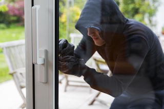 Burglar using special tools to break in  a house