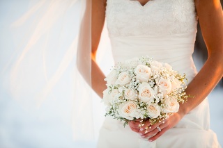Bride holding wedding bouquet with Roses and Baby?s breath flowers