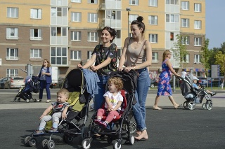 Moscow, Russia - September 1st, 2018: Unidentified women walk with their small kids at residential area in Moscow, Russia. Increase in birth rate is an important problem for Russian government.