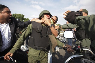 Odporcovia Nicolása Madura sa bijú s bolívijským vojakom lojálnym venezuelskému prezidentovi počas zrážok neďaleko vojenskej základne La Carlota v Caracase.