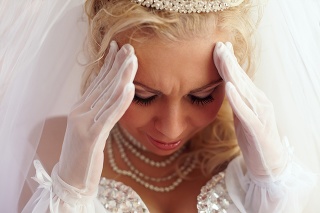 close-up portrait of beautiful bride frown on the troubles and pain. white background