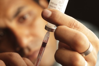 A patient loads insulin for his routine shot.