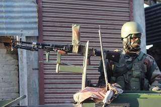 Security personnel take positions during a cordon and search operation in tarzoa village of sopore jammu and kashmir