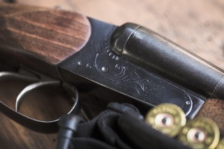 Shotgun with cartridges on a wooden background