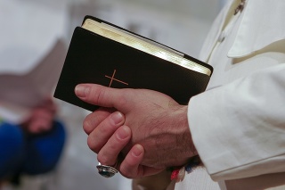 Man in popes garment holding holy bible. Adobe RGB for better color reproduction.
