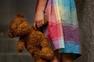 Cropped view of a little girl holding a teddy bear