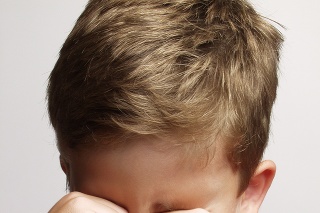 exhausted and sad little kid portrait,rubbing his eyes.