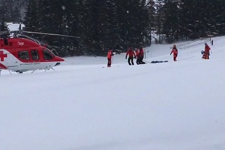 Horskí záchranári previezli zranenú lyžiarku k vrtuľníku.