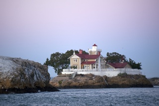lighthouse and inn on a rocky island