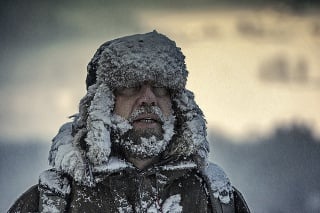 Portrait of man outside in winter snowstorm