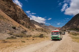 Local bus on the rural road surrounding by mountains in Annapurna region, Nepal.