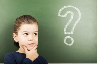 little student in front of the blackboard with question mark