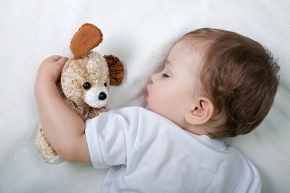Little child sleeping with teddy bear