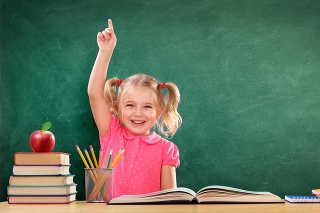 Little Student Sitting On The Desk With Blackboard and Books