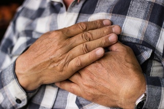 Man clutching his chest. Pain, possible heart attack